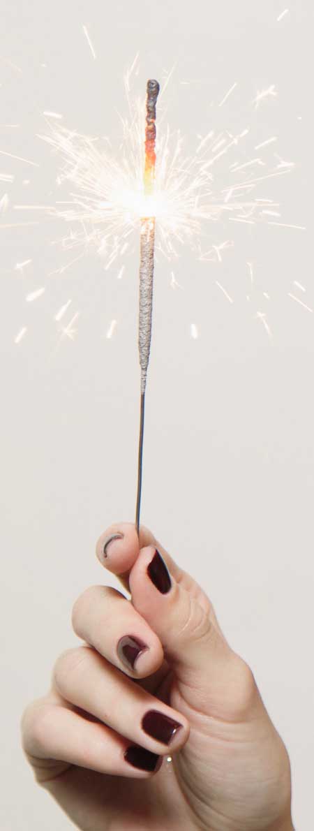 a hand holding holiday sparkler