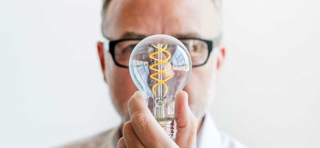 image of man holding a lightbulb